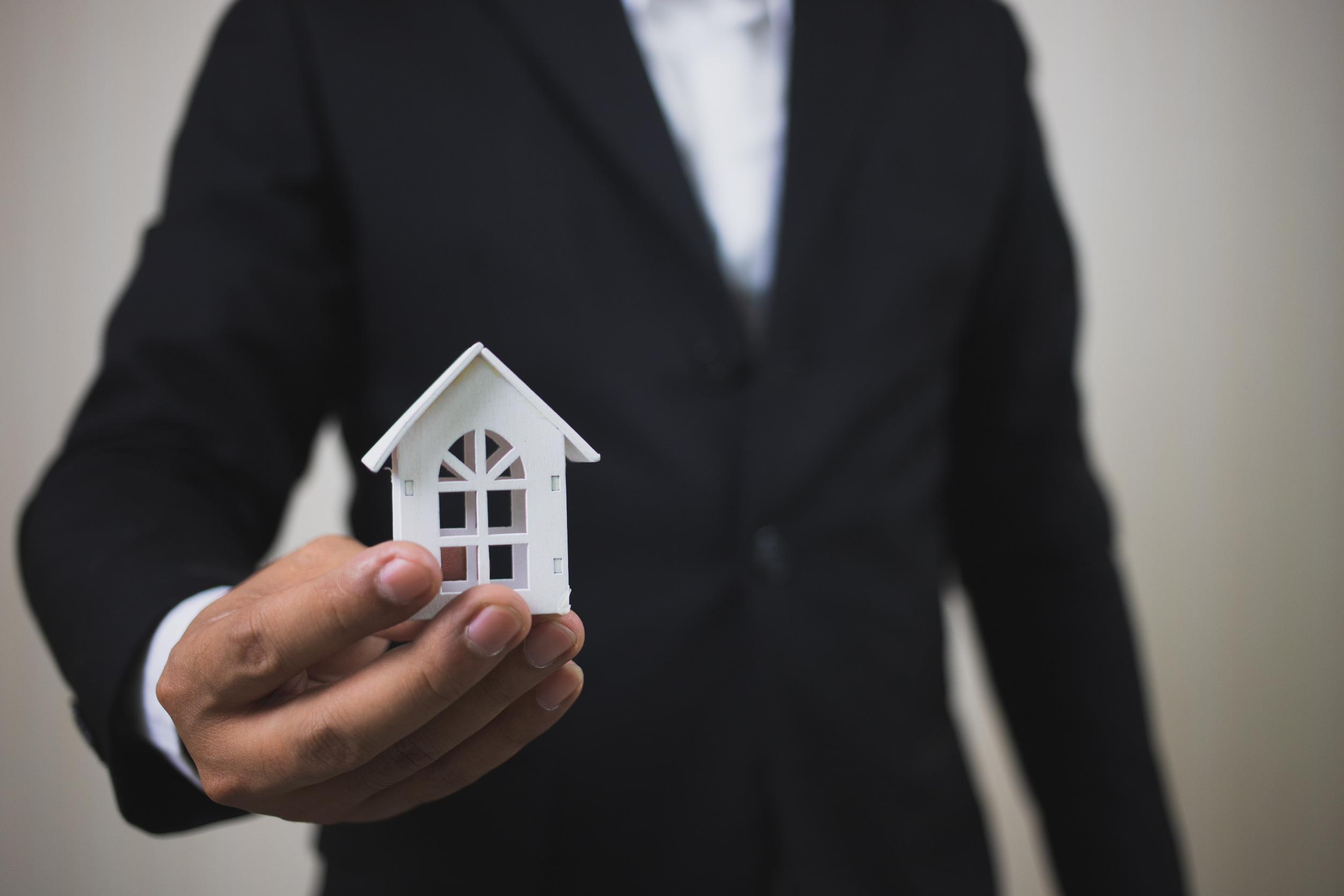 Man holding a model home